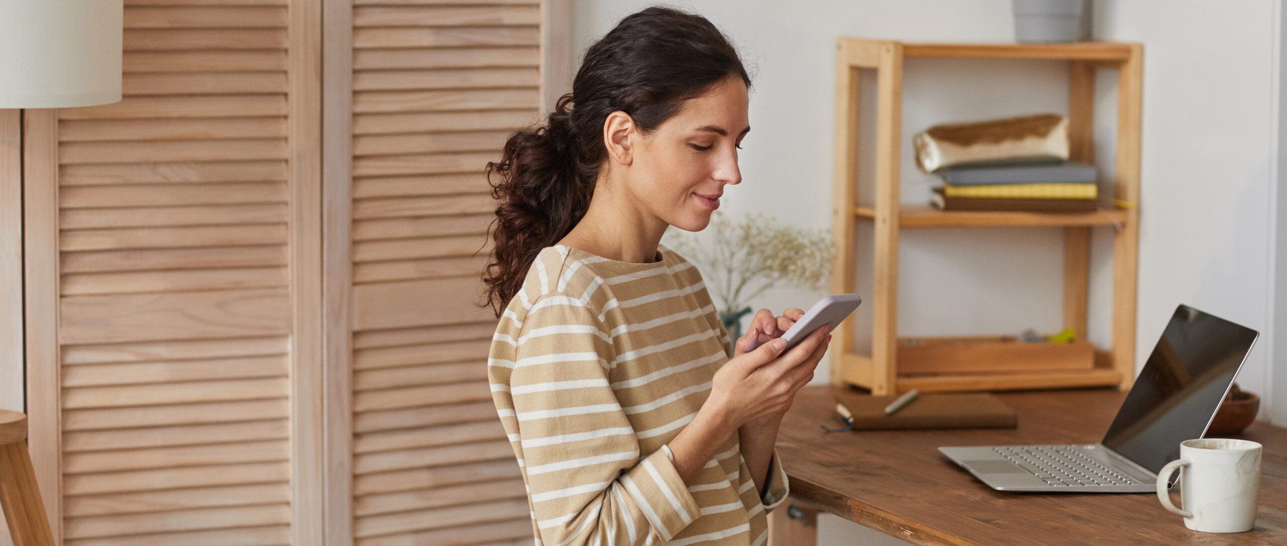 Image of woman on mobile phone reviewing FAQs