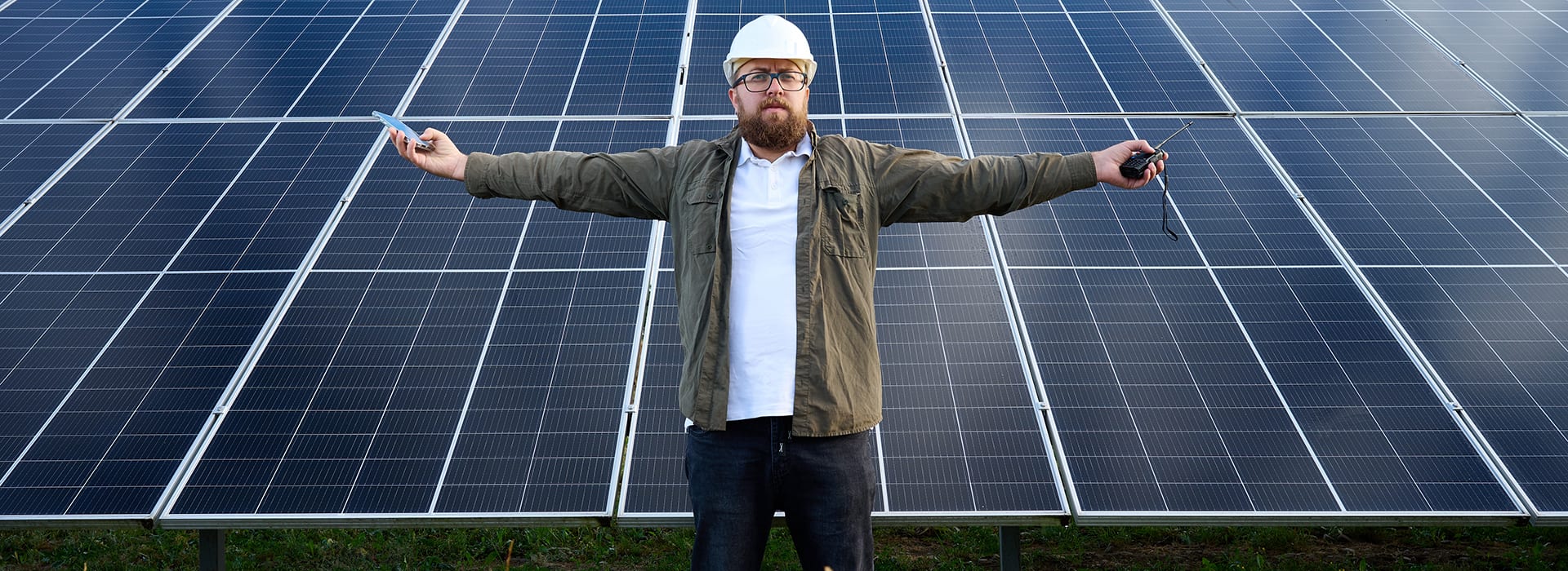 Image of man standing in front of solar panels