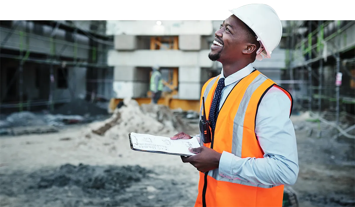 Photo of smiling man at construction site