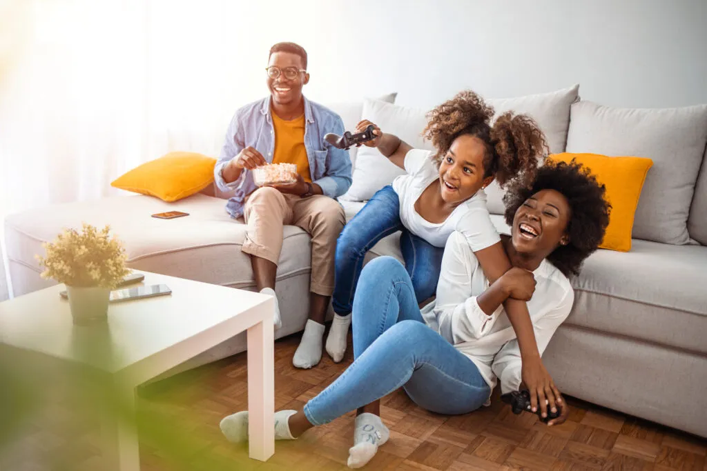 Family sitting together in the living room, enjoying broadband services from CDE Lightband