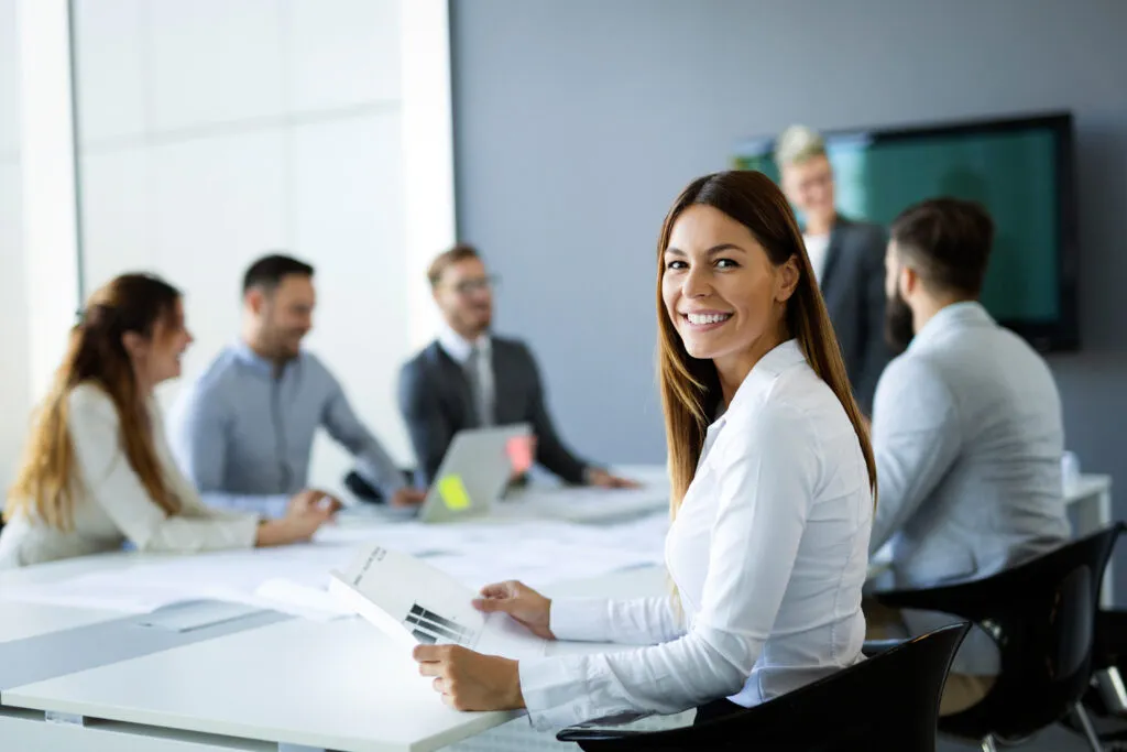 Image of women, smiling during business meeting at conference table