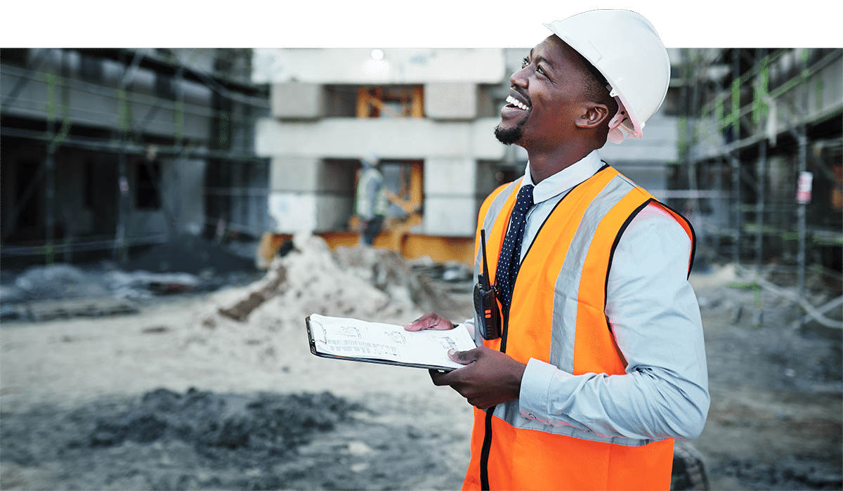 Photo of smiling man at construction site