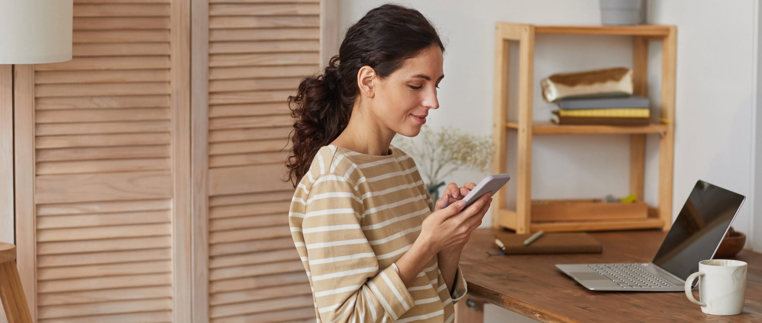 Image of woman using mobile phone to sign up for text alerts