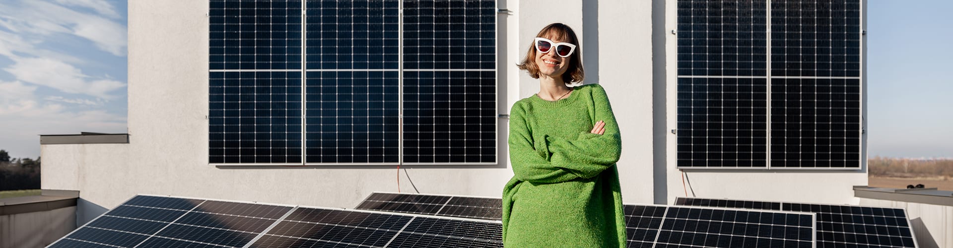 Young woman, smiling, standing in front of solar panels, Clarksville, Tennessee
