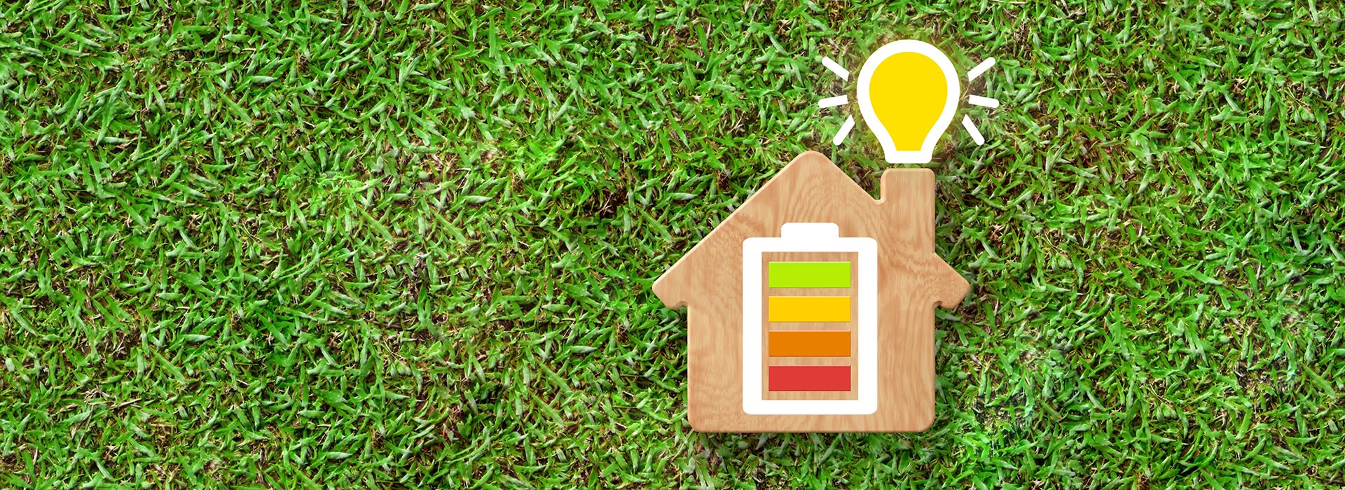 Image of home icon with energy iconography on springtime grass background